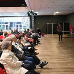 Trois premiers rangs d'un colloque écoutant une intervenante
